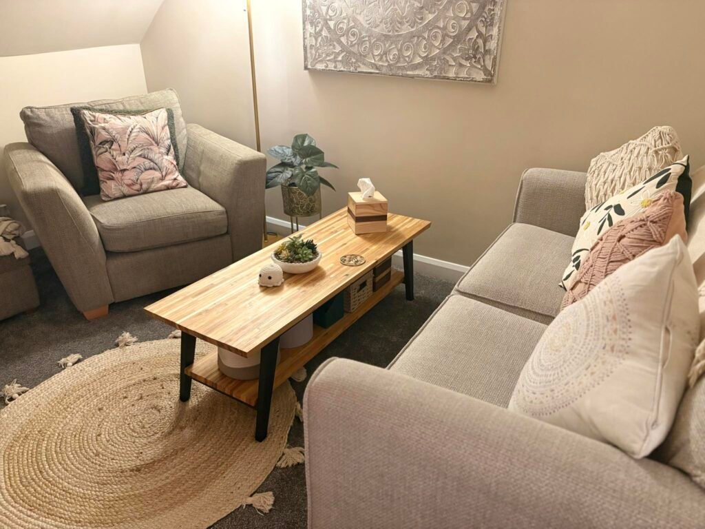 Inside Laura Heslop's therapy room. Two sofas face each other with a small coffee table in the centre.